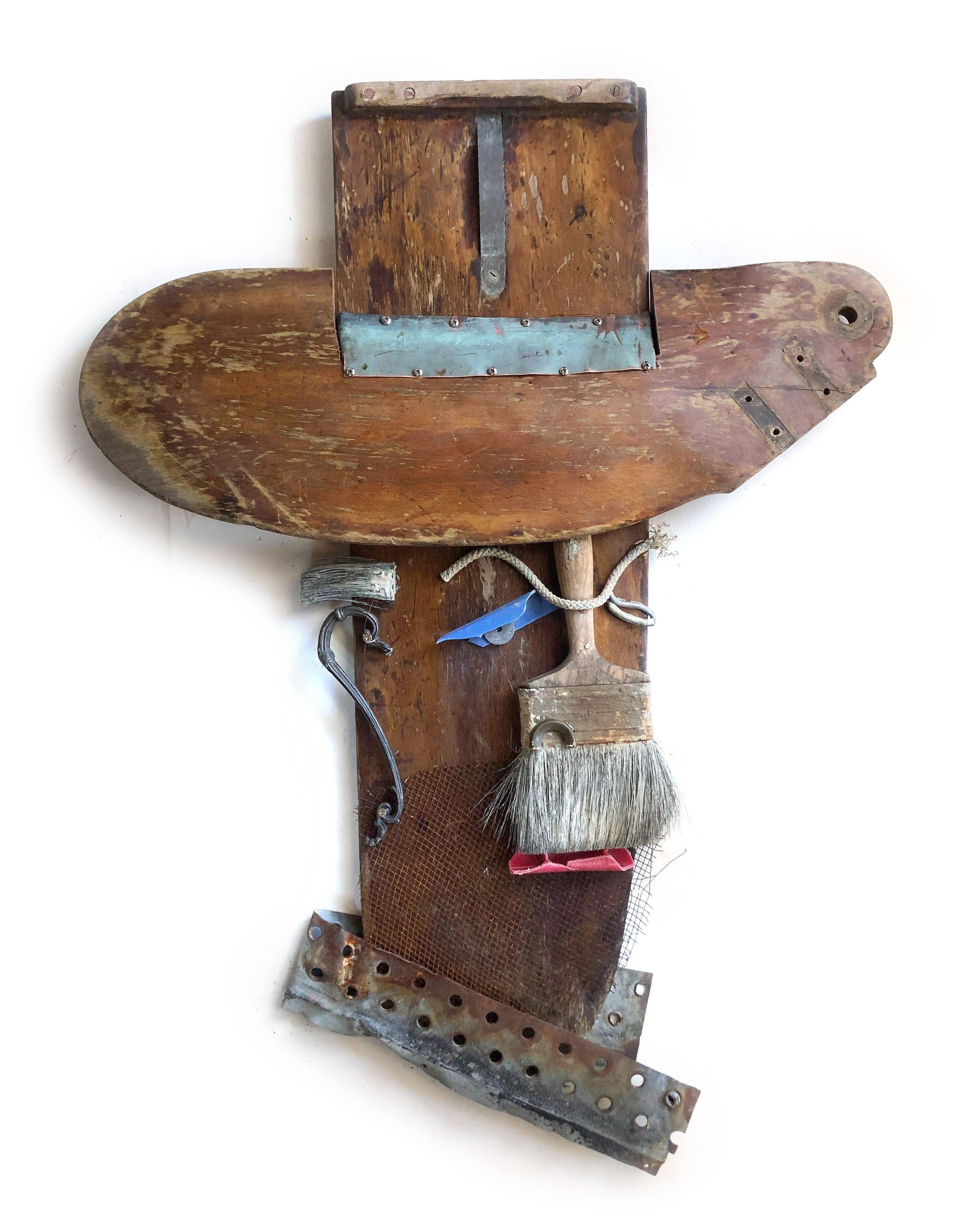 Assemblage made of wooden keel and rudder, paintbrush and other found objects